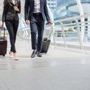 Travelers walking together with luggage