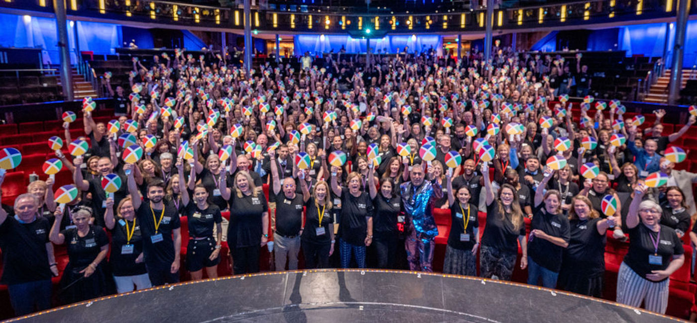 Image: CoNexion attendees hold up their Nexion fans during a general session.  (Photo Credit: Nexion)