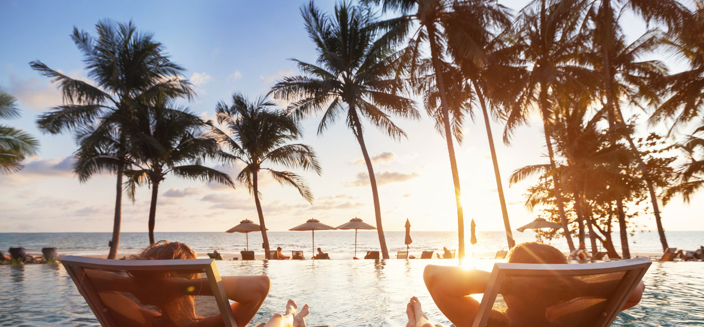 Image: Romantic couple at beach hotel. (photo via anyaberkut / iStock / Getty Images Plus)